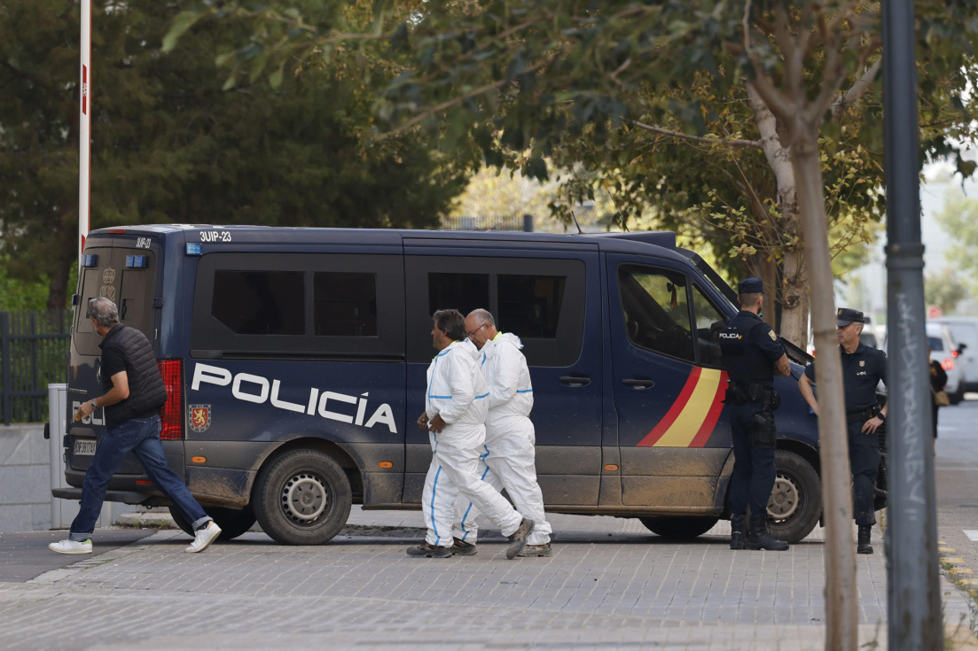 Efectivos de los servicios funerarios junto a un furgón policial. EFE/ Ana Escobar